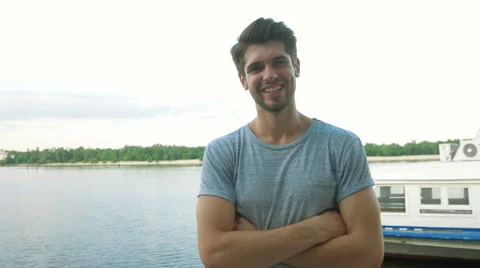 Portrait of a handsome smiling man looking at the camera in city Stock Footage 68599577