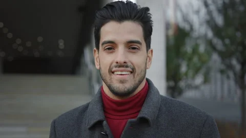 Portrait of the handsome smiling multi ethnic man sitting in the stairs in the Stock Footage 243356388