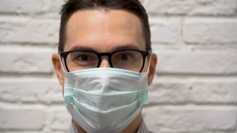 Portrait of handsome smiling sick guy. Man breathes in protective medical mask  Stock Footage 127783176