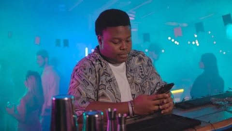 Portrait of handsome sociable plump afro-american boy using mobile phone sitting Stock Footage 115363442
