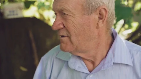 Portrait of the handsome wrinkled senior sincerely smiling at camera. 4K Stock Footage