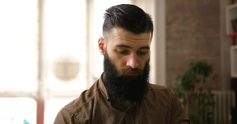 Portrait of a handsome young bearded man works in the office Stock Footage