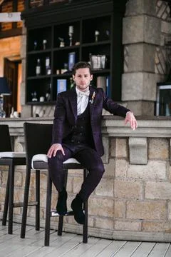 Portrait of the handsome young bridegroom posing before the wedding ceremony Stock Photos