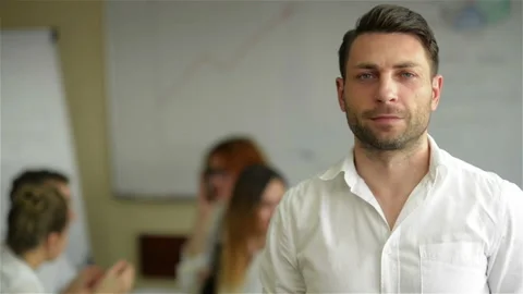 Portrait of a handsome young business man standing in an office. Smart caucasian Stock Footage