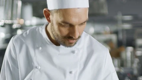Portrait of a Handsome Young Chef Smiling On Camera in Slow Motion.  Stock Footage 77024139
