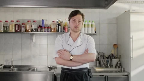 Portrait of a handsome young chef  standing on kitchen. Stock Footage 131457577