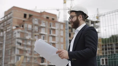 Portrait of handsome young engineer on building site looking at the camera. The Stock Footage 109633948