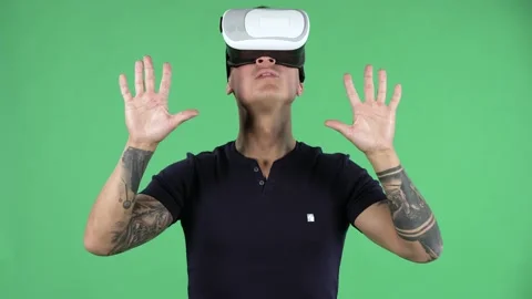 Portrait of a handsome young guy with virtual reality goggles. Green screen. Stock Footage 139147935
