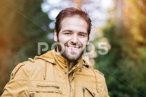 Portrait of a handsome young man in autumn. fall. graded with a flare Stock Photos