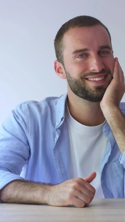 Portrait of a handsome young man with a beard and blue eyes, smiling Vídeos de archivo 344757194