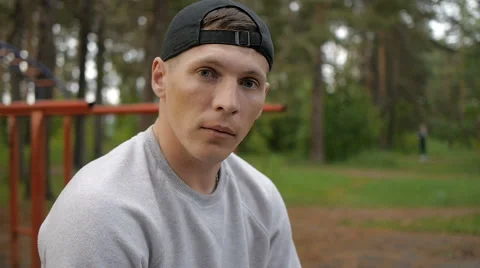 Portrait of handsome young man with cap in forest Stock Footage 64017440