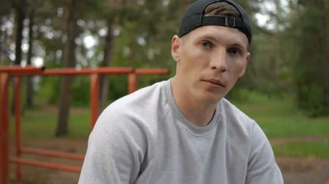 Portrait of handsome young man with cap in forest Stock Footage 64017553