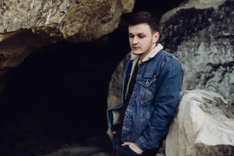 Portrait of a handsome young man in a denim jacket outdoors Stock Photos