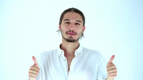 Portrait of handsome young man gesturing double thumbs up. Studio shot Stock Footage 135603900