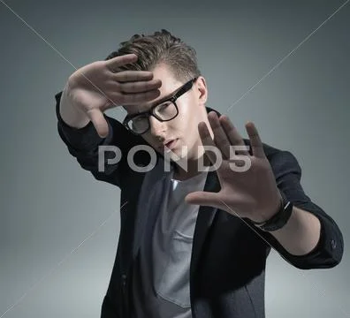 Portrait of a handsome young man in a modern pose Stock Photos