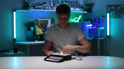 Portrait of handsome young man pulls accessories of new action camera out of Stock Footage 249010297