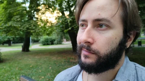 Portrait of a handsome young man resting in a city park 库存影片 218948385