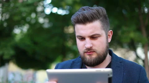 Portrait of a handsome young man working with a tablet Stock Footage 50982120