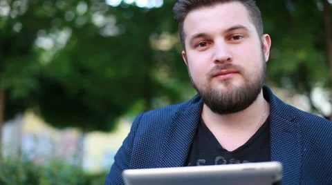 Portrait of a handsome young man working with a tablet Stock Footage 50982157