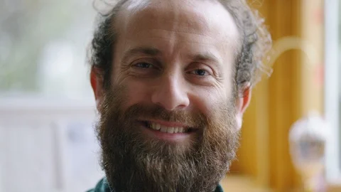 Portrait of happy and comfortable middle aged man with a beard smiling to camera Stock Footage 101158082