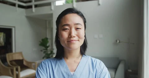Portrait of happy asian female nurse at work in hospital, smiling to camera Stock Footage