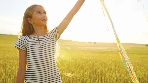 Portrait of happy beatiful girl with balloons smiling on camera on the field Stock Footage