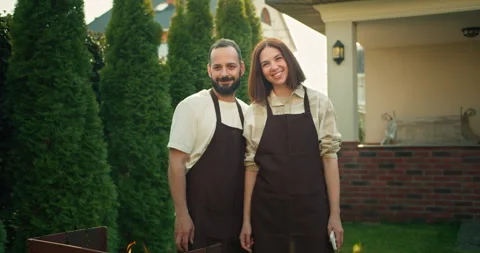 Portrait of a happy brunette guy with a beard together with his brunette Stock Footage 278714098
