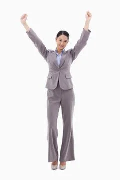 Portrait of a happy businesswoman posing with the arms up Stock Photos