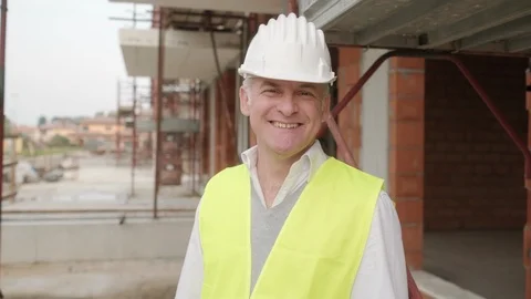 Portrait Of Happy Construction Site Supervisor Talking To Manual Worker Stock Footage 98801775