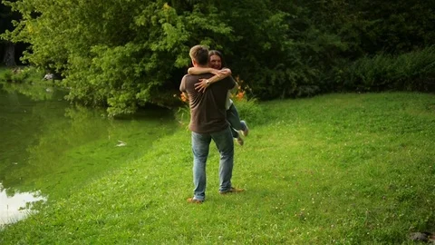 Portrait of Happy Couple Enjoying Spending Time Together in the Park. Strong Boy Stock Footage