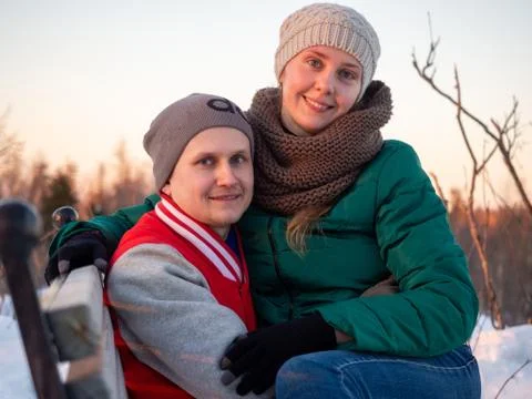 Portrait of happy couple looking while holding each other in winter at sunset Stock Photos