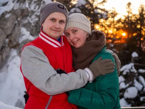 Portrait of happy couple looking while holding each other in winter at sunset Stock Photos