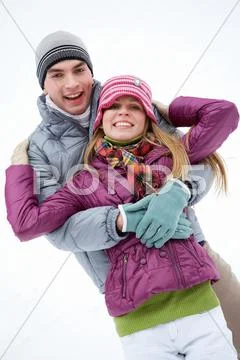 Portrait of happy couple in winter clothes looking at camera Stock Photos