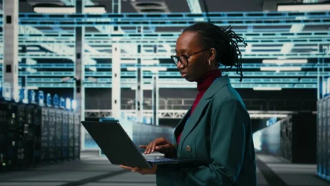 Portrait of happy data center system administrator using laptop software Stock Footage 329592961