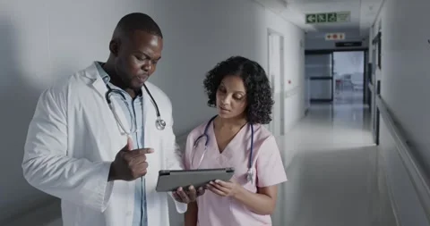 Portrait of happy diverse doctors using tablet in hospital in slow motion Stock Footage 337536815