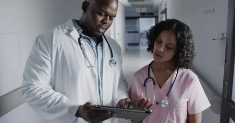Portrait of happy diverse doctors using tablet in hospital in slow motion Stock Footage 338433918