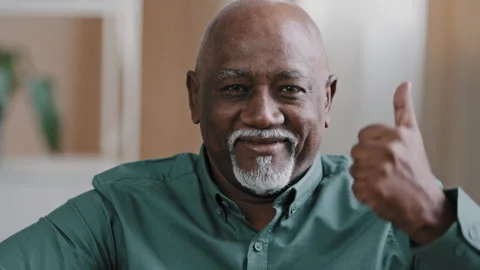 Portrait of happy elderly african american man smiling old senior putting two Stock Footage 170704172