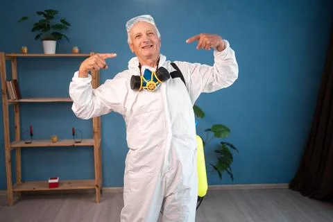 Portrait of happy Elderly pest control worker point index fingers on opened m Stock Photos
