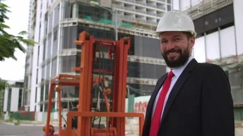Portrait happy engineer in protective helmet business suit posing,smiling Stock Footage 166349483