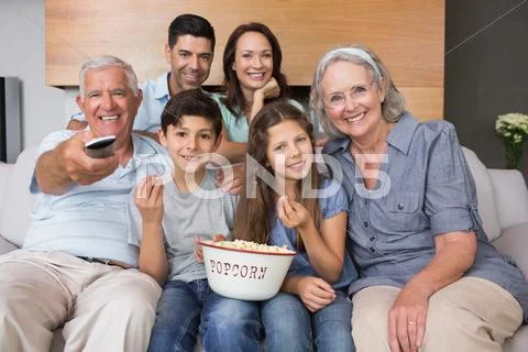 Portrait of happy extended family watching tv in living room Stock-Fotos
