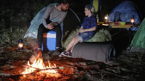 Portrait of happy family in campground into forest, father played with child Stock Footage