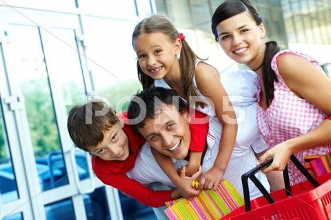 Portrait of happy family of four having fun after shopping Stock Photos