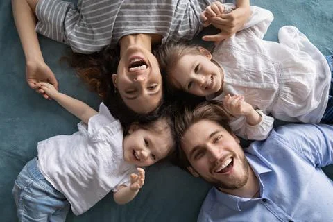 Portrait of happy family with small daughters Stock Photos
