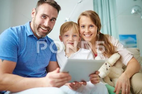 Portrait of a happy family using touchpad Stock Photos