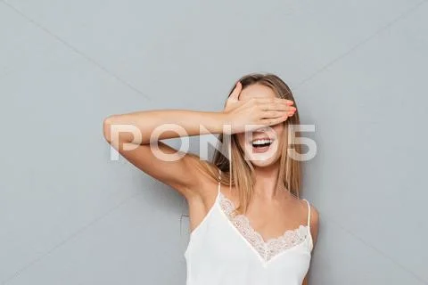 Portrait of a happy female teenager covering her eyes Stock Photos