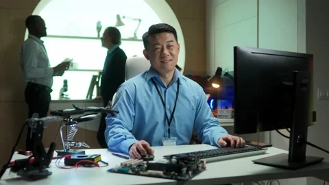 Portrait of happy focused professional developer in IT company using computer Stock Footage 228885194