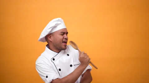 Portrait happy funny man chef holding kitchen utensils dancing and singing music Stock Footage 172283953