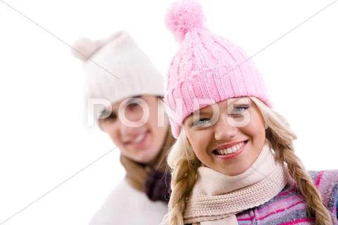 Portrait of happy girl in pink knitted cap on background of her boyfriend Stock Photos
