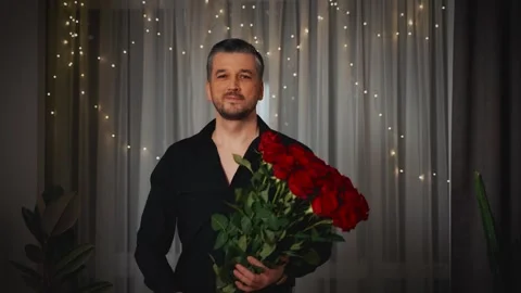 Portrait happy handsome man hands holding huge bouquet of red roses scarlet Stock Footage 311984532