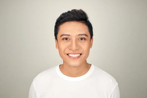 Portrait of happy handsome young Asian man is smiling on white background Stock Photos